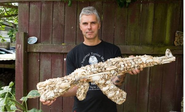 Artist creates a sculpture of an AK-47 from animal bones