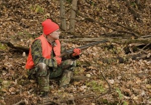 hunter sitting in the autumn woods waiting for game