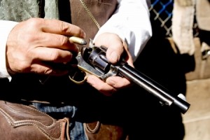 Upclose horizontial photo loading bullets into a handgun