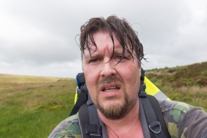 Man with wet hair and sweaty face looking exhausted and challenged